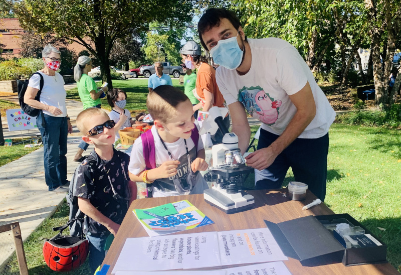 Tim likes to observe soil microbes and show the to children.